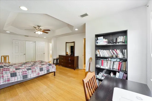 a spacious bedroom with a bed and a book shelf
