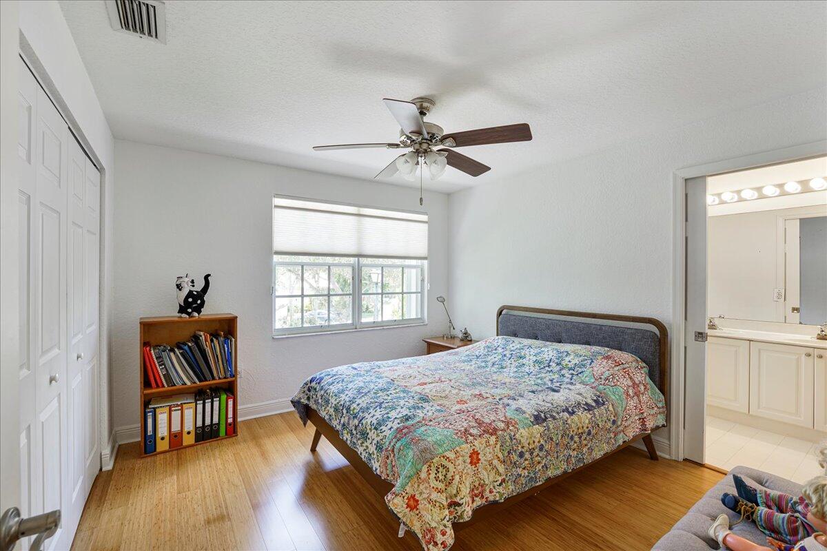 19059 Skyridge Circle Boca Raton, FL 33498 - Photo 31 of 40 a bedroom with a bed and a chandelier