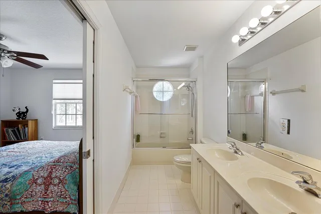 a bathroom with a double vanity sink mirror double and shower