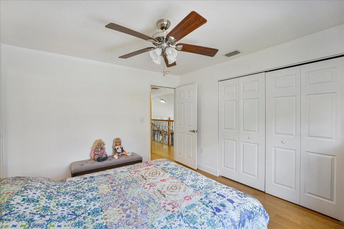 19059 Skyridge Circle Boca Raton, FL 33498 - Photo 35 of 40 a bedroom with a bed and cabinets