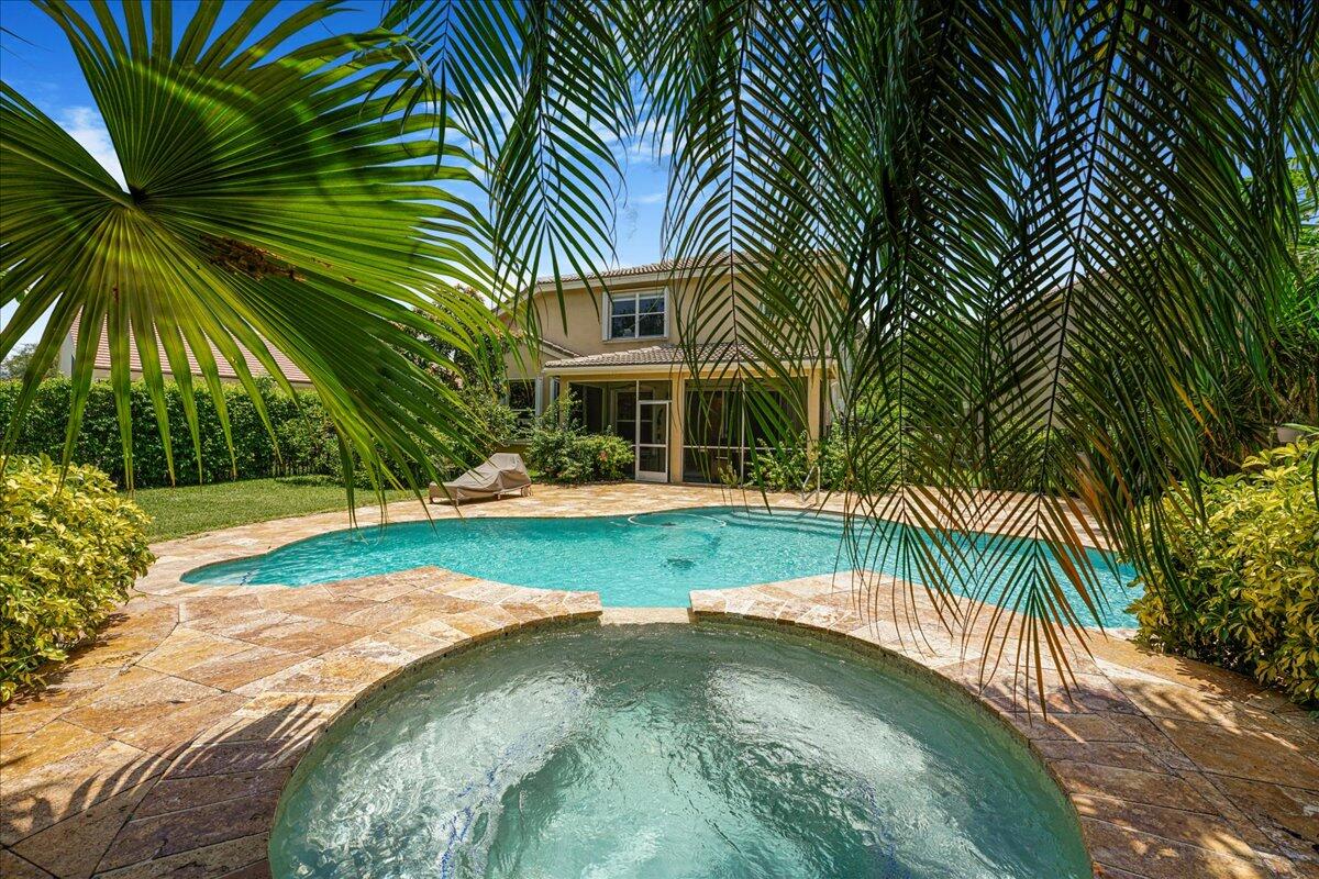19059 Skyridge Circle Boca Raton, FL 33498 - Photo 4 of 40 a view of a swimming pool with a yard and palm trees