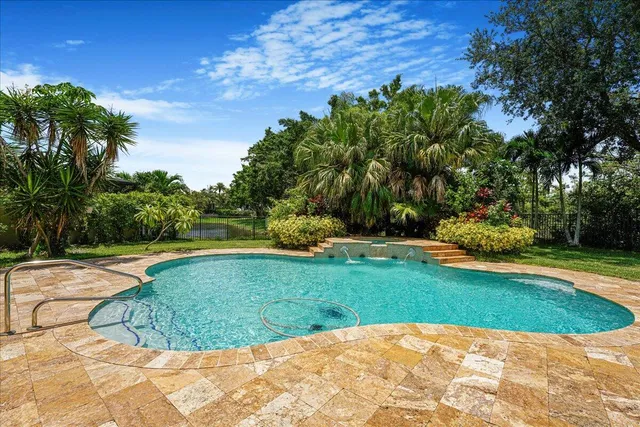 a view of a swimming pool with a yard
