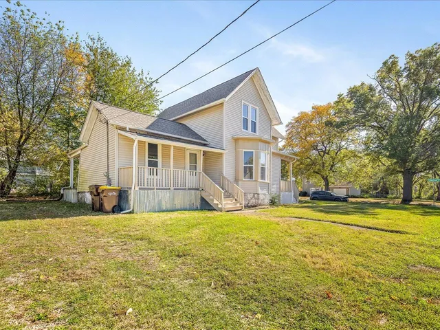 a view of a house with a yard and swimming pool