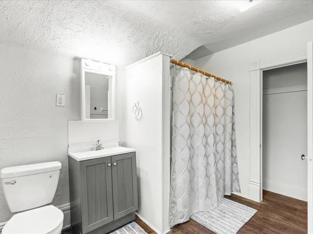 a bathroom with a toilet a sink and shower