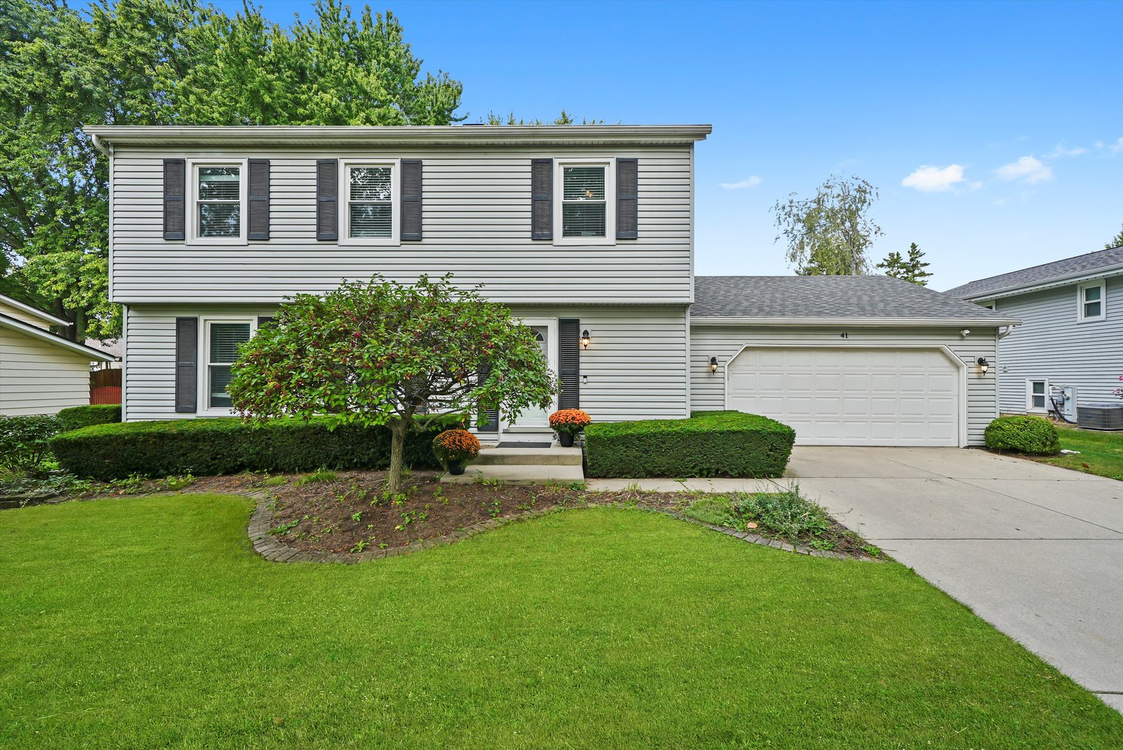 41 Lockman Circle Elgin, IL 60123 - Photo 1 of 46 a front view of a house with a yard and garage