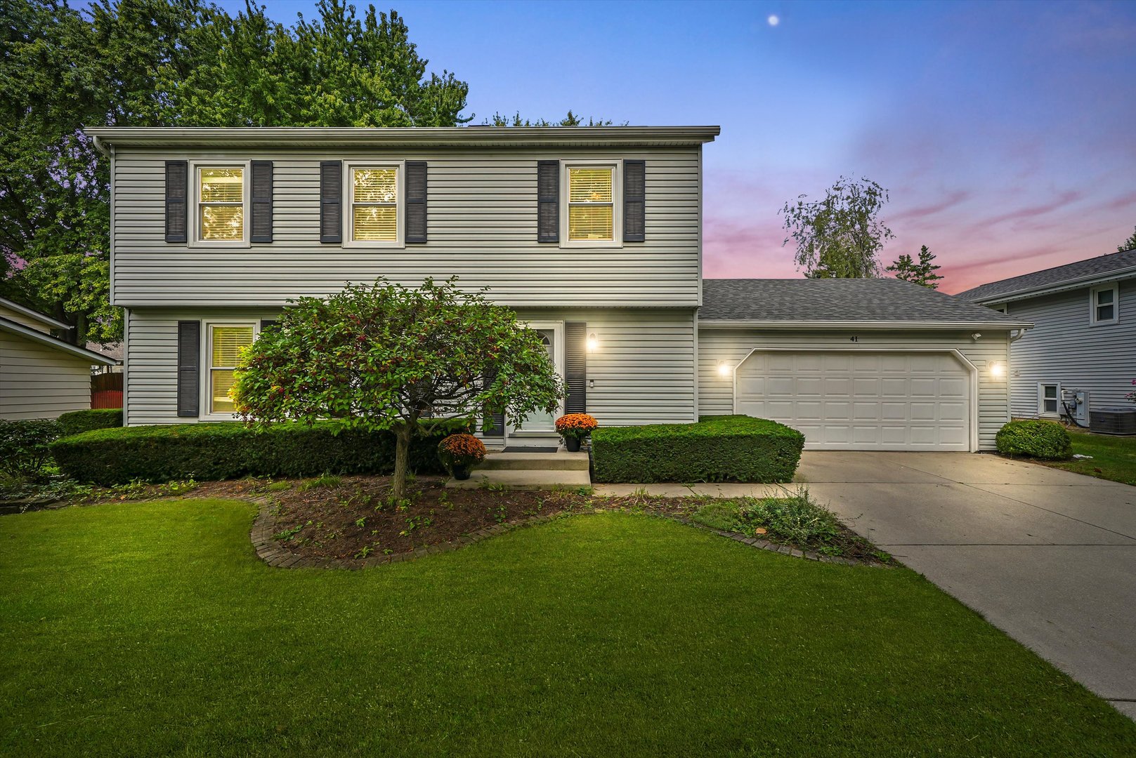 41 Lockman Circle Elgin, IL 60123 - Photo 46 of 46 a front view of a house with a garden and plants