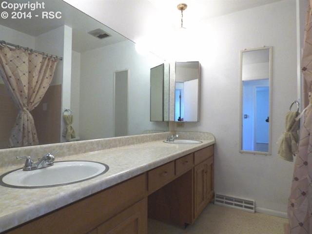 1556 Collins Road Colorado Springs, CO 80920 - Photo 15 of 25 Full bath with dual vanity is located on the upper level.