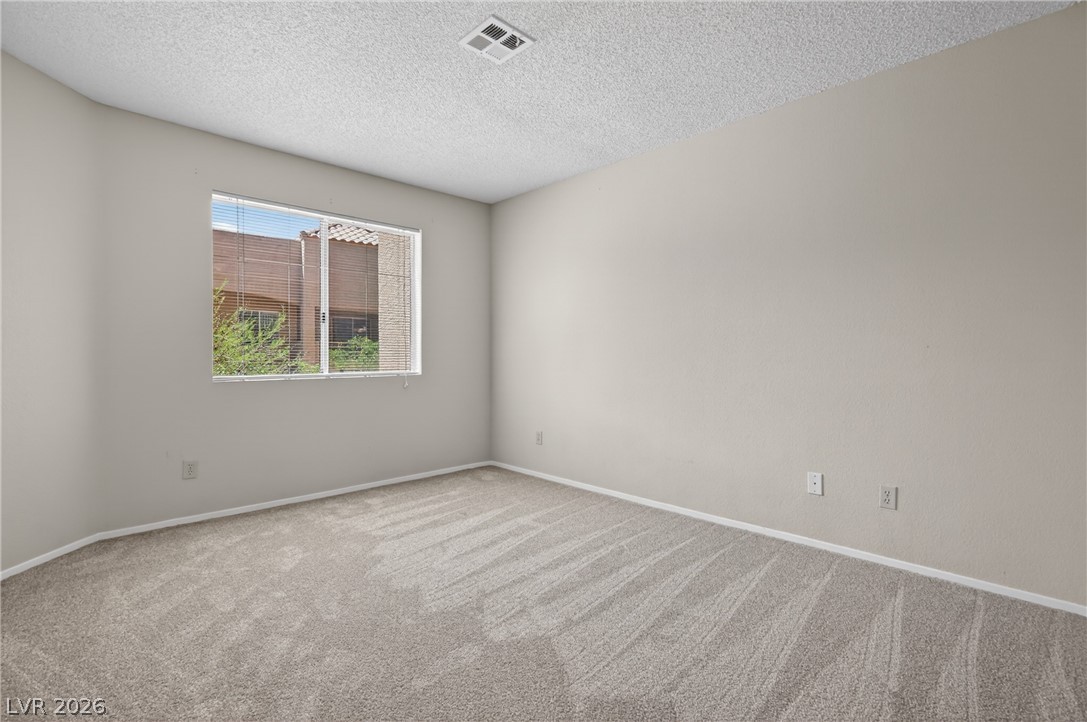2241 Highpointe Drive, Unit 101 Laughlin, NV 89029 - Photo 15 of 23 This bright and airy room features soft carpeting and a window overlooking lush greenery.