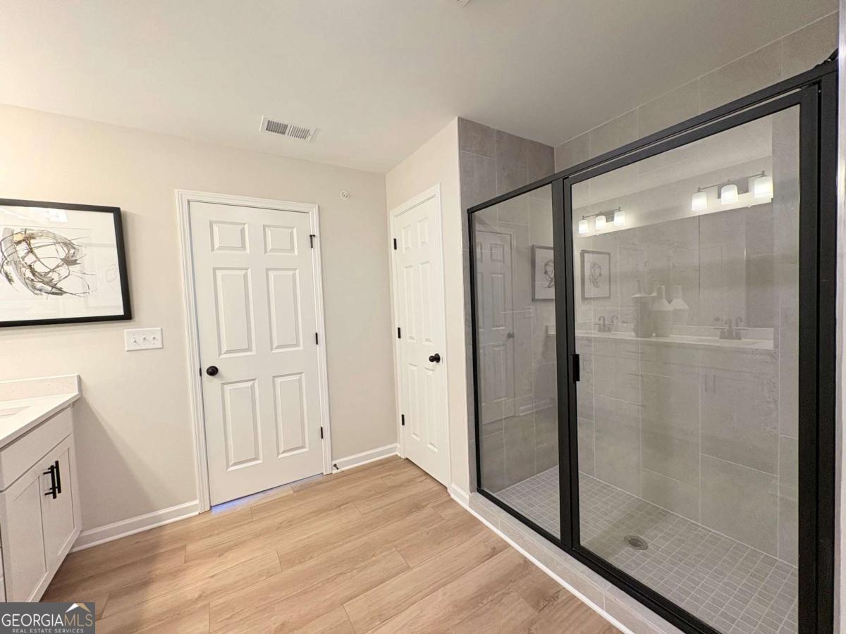 6155 Molo Lane Cumming, GA 30041 - Photo 22 of 29 a view of a bathroom with wooden floor and bathroom