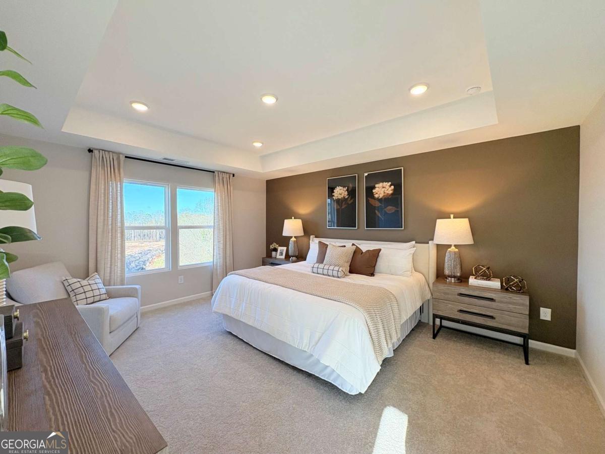 6155 Molo Lane Cumming, GA 30041 - Photo 24 of 29 a spacious bedroom with a bed and window