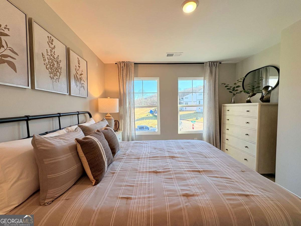 6155 Molo Lane Cumming, GA 30041 - Photo 26 of 29 a bedroom with a bed and window