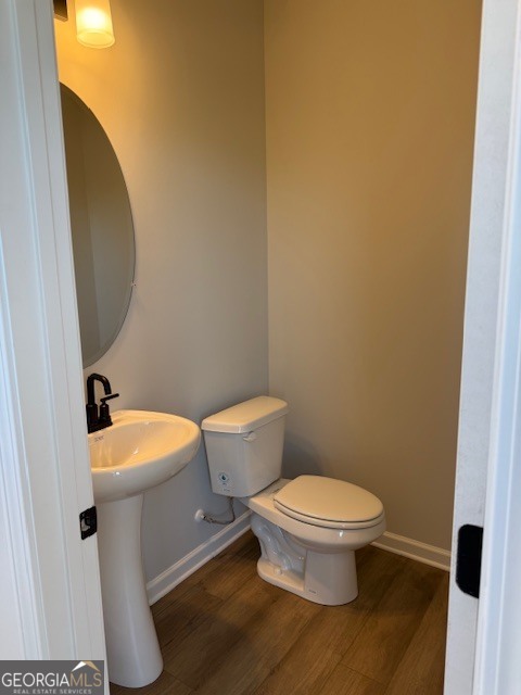 6155 Molo Lane Cumming, GA 30041 - Photo 4 of 29 a white toilet sitting next to a bathroom sink