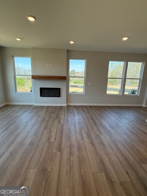 6155 Molo Lane Cumming, GA 30041 - Photo 5 of 29 an empty room with wooden floor and windows