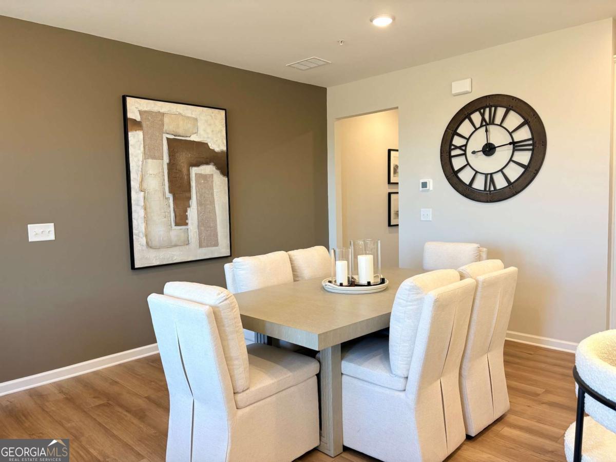6155 Molo Lane Cumming, GA 30041 - Photo 10 of 29 a view of a dining room with a table and chairs