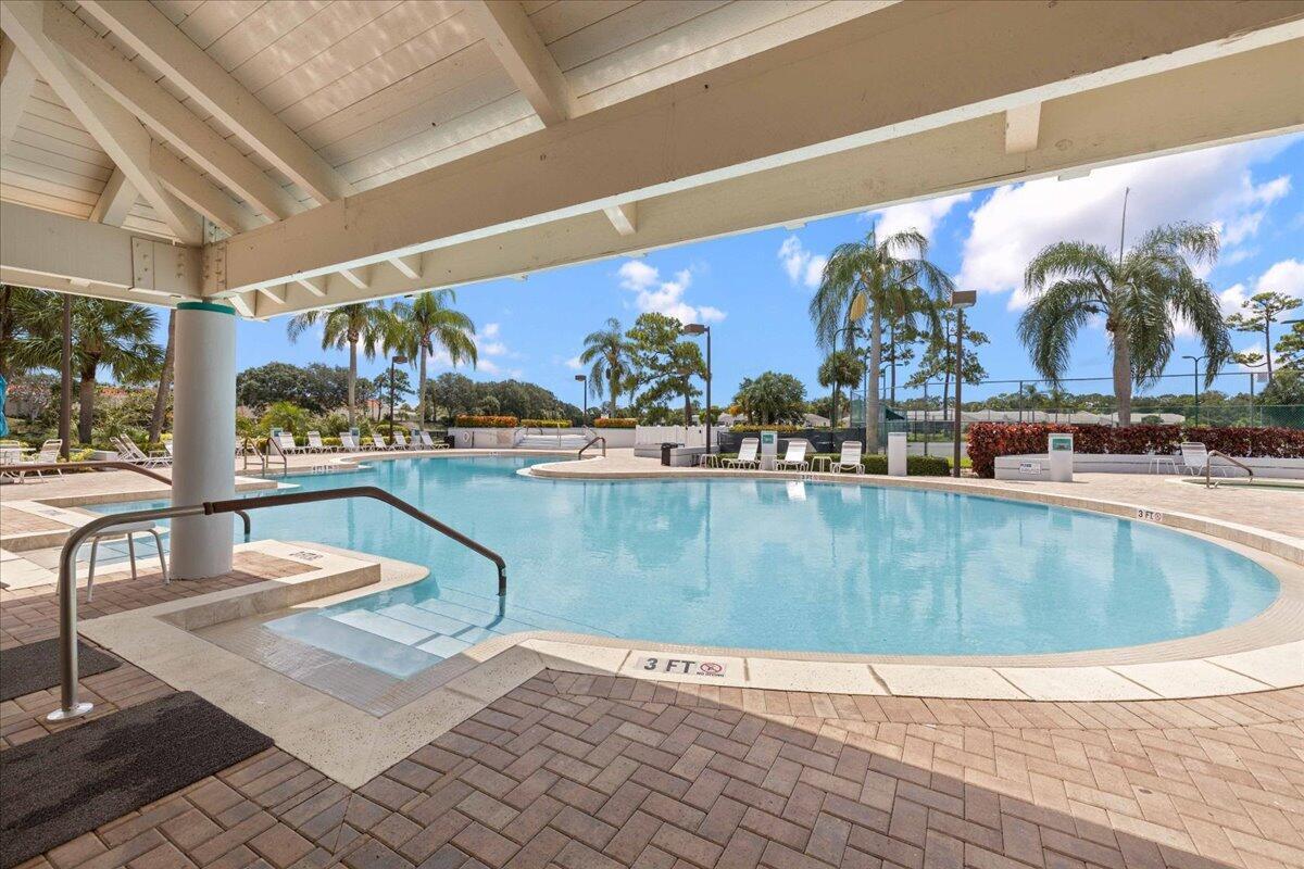2804 Waters Edge Circle Greenacres, FL 33413 - Photo 66 of 74 a view of a swimming pool with outdoor seating