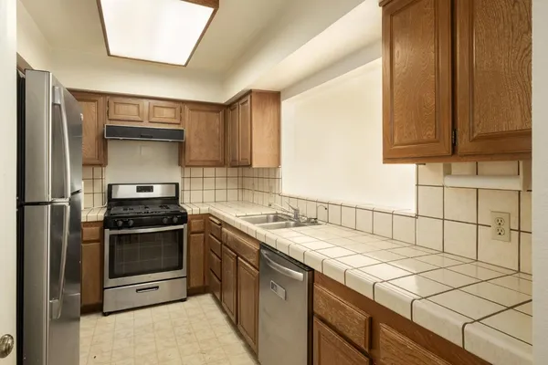 a kitchen with a sink stove and cabinets