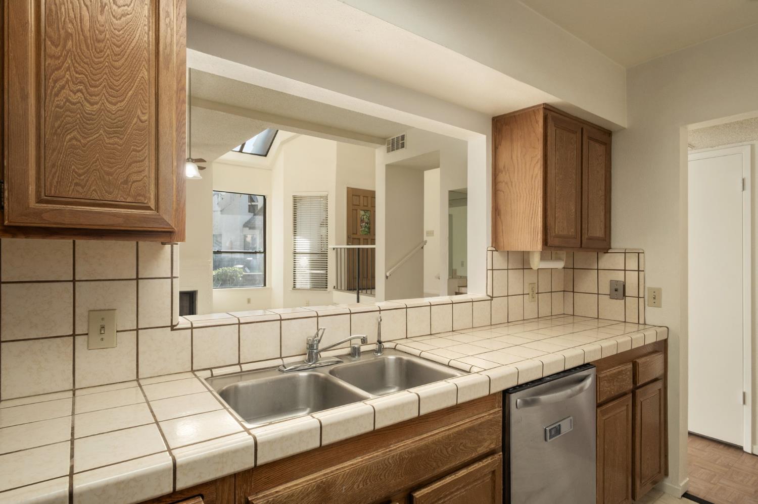 2890 Huntington Boulevard, Unit 149 Fresno, CA 93721 - Photo 13 of 30 a kitchen with a sink and a window