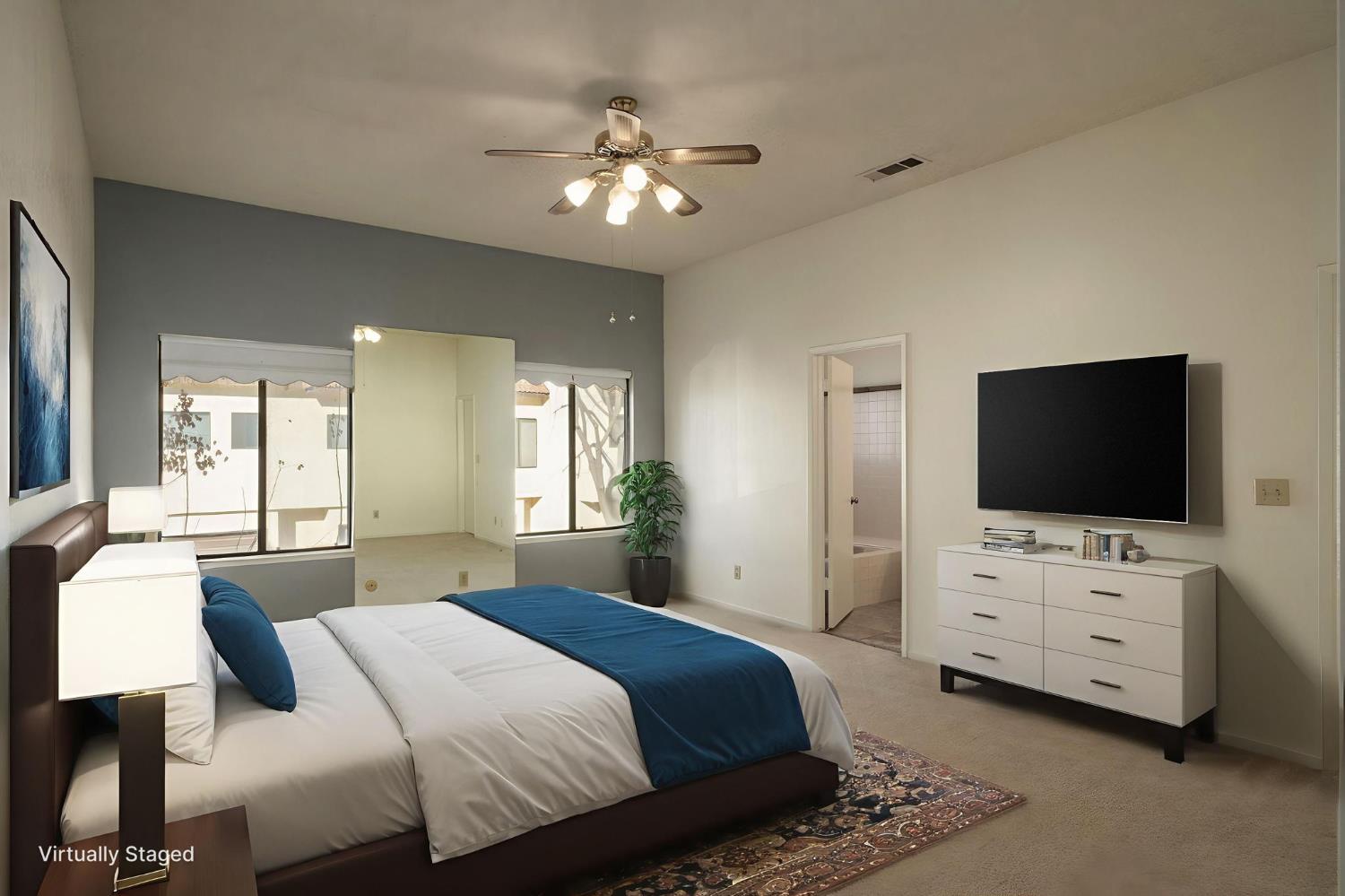 2890 Huntington Boulevard, Unit 149 Fresno, CA 93721 - Photo 15 of 30 a bedroom with bed tv and view of bathroom