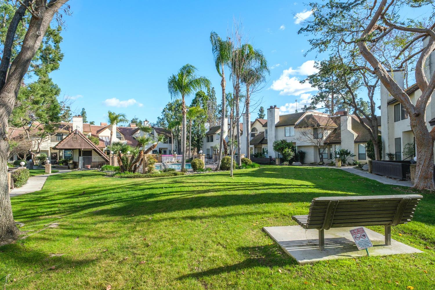 2890 Huntington Boulevard, Unit 149 Fresno, CA 93721 - Photo 27 of 30 a view of a park with a bench and trees