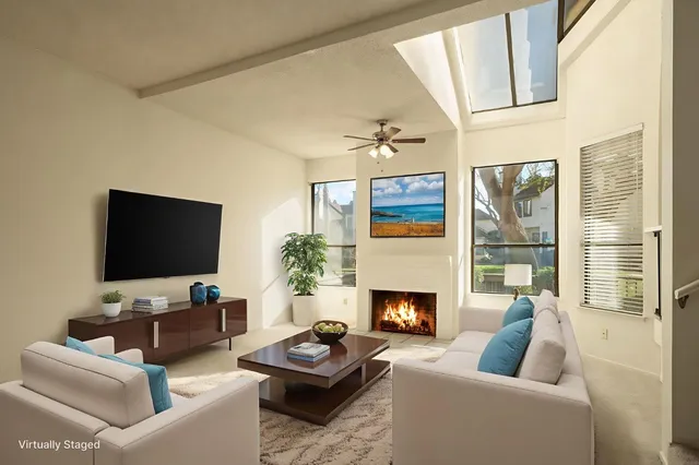 a living room with furniture a fireplace and a flat screen tv