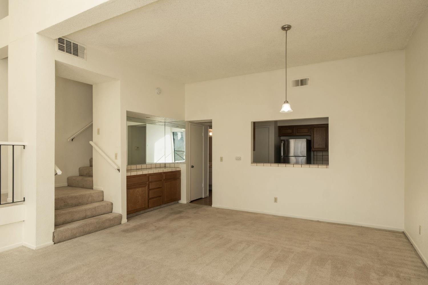 2890 Huntington Boulevard, Unit 149 Fresno, CA 93721 - Photo 9 of 30 a view of an empty room with a fireplace