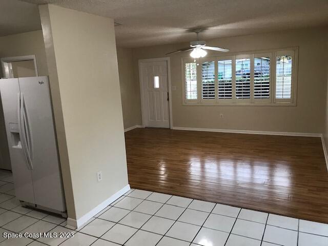 814 Hampton Way Merritt Island, FL 32953 - Photo 4 of 9 an empty room with wooden floor and windows