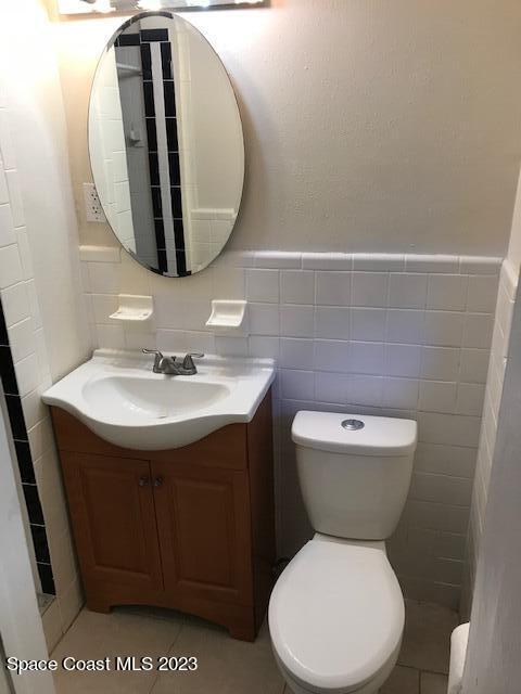 814 Hampton Way Merritt Island, FL 32953 - Photo 6 of 9 a white toilet sitting next to a bathroom sink