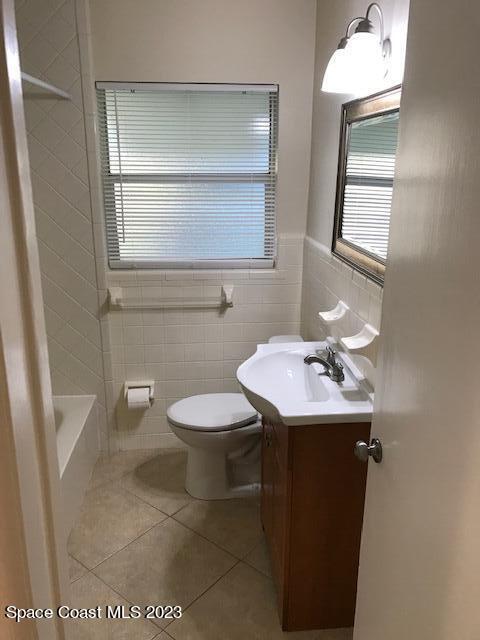 814 Hampton Way Merritt Island, FL 32953 - Photo 7 of 9 a bathroom with a toilet sink and mirror