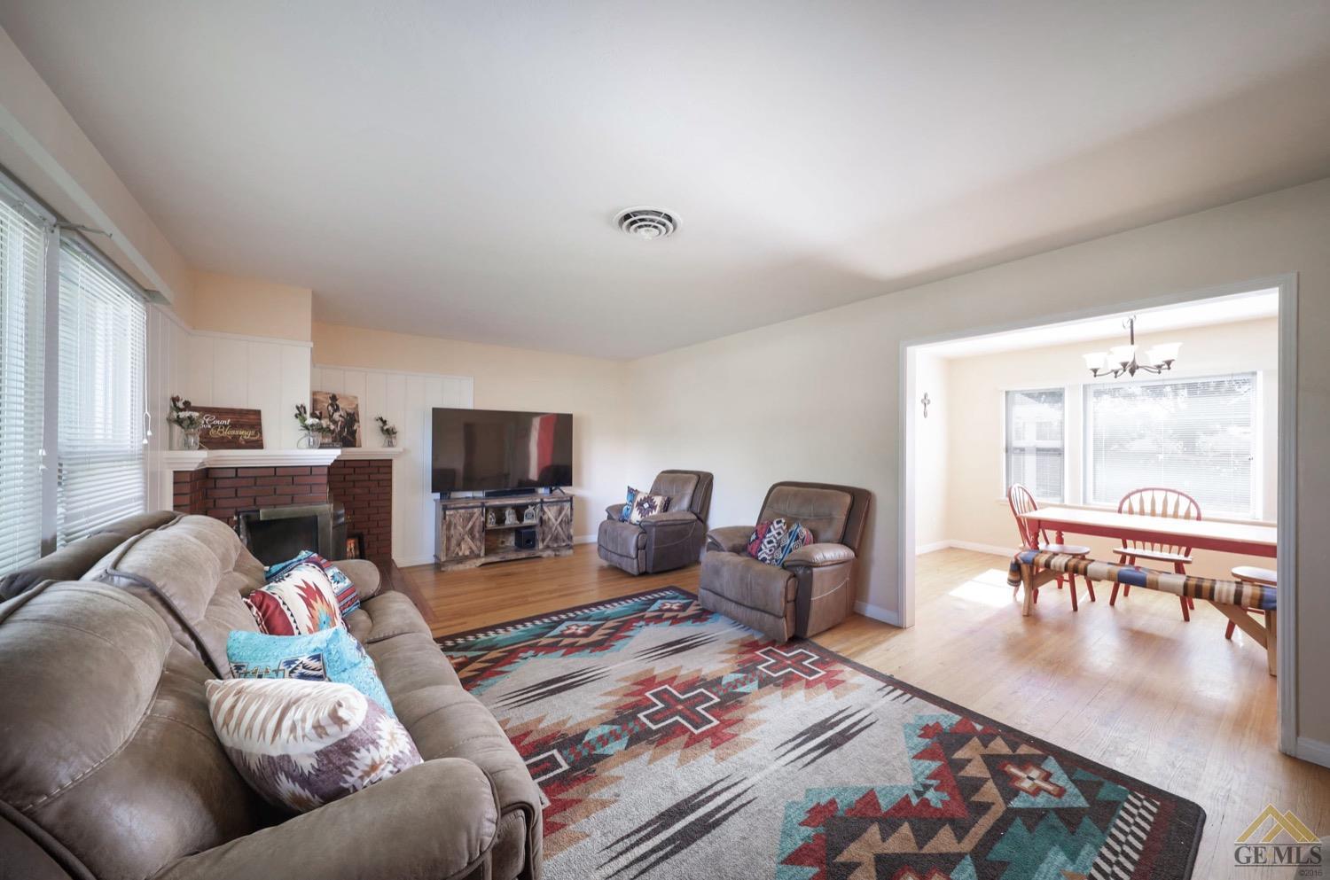 Undisclosed Address Bakersfield, CA 93308 - Photo 12 of 22 a living room with furniture and a flat screen tv