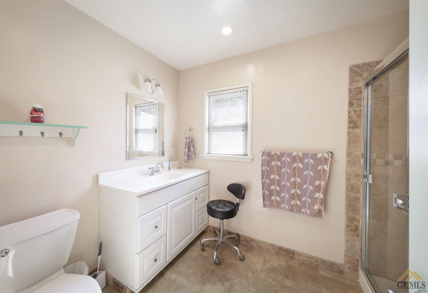Undisclosed Address Bakersfield, CA 93308 - Photo 17 of 22 a bathroom with a toilet sink and mirror