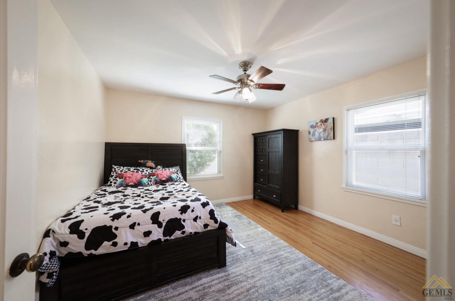 Undisclosed Address Bakersfield, CA 93308 - Photo 6 of 22 a bedroom with a bed and wooden floor