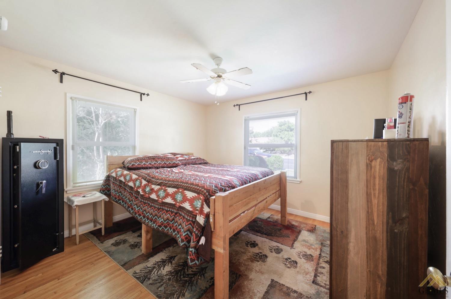 Undisclosed Address Bakersfield, CA 93308 - Photo 7 of 22 a bedroom with a bed and a chandelier