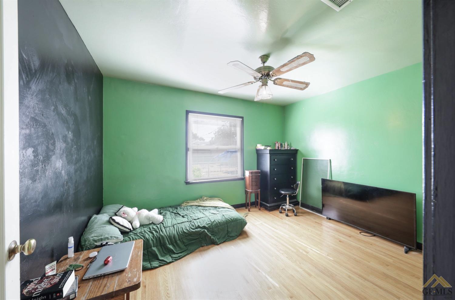 Undisclosed Address Bakersfield, CA 93308 - Photo 9 of 22 a bedroom with a bed and a chandelier fan