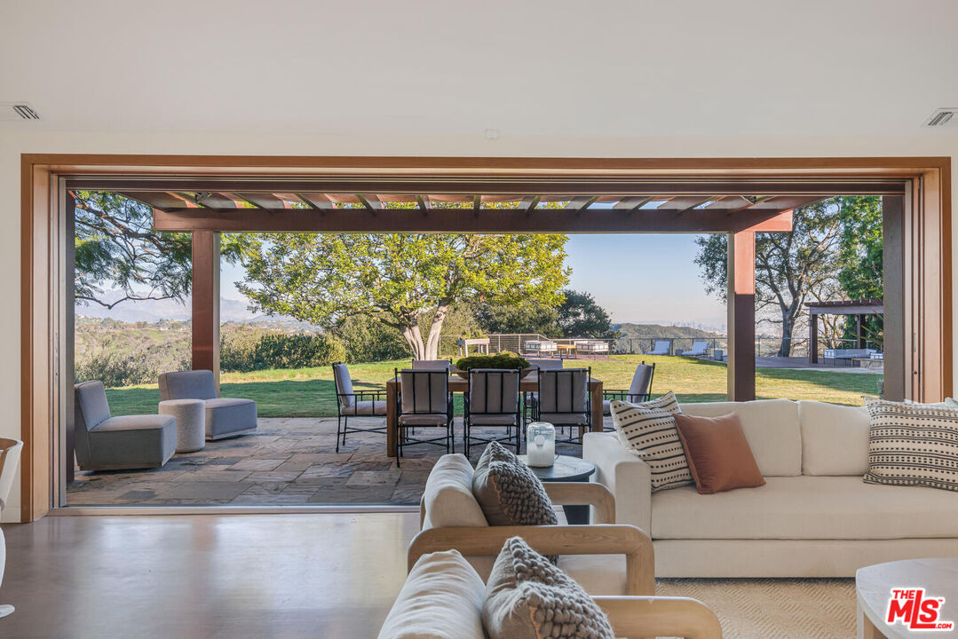 2232 Stradella Road Los Angeles, CA 90077 - Photo 11 of 48 a living room with furniture and a large window