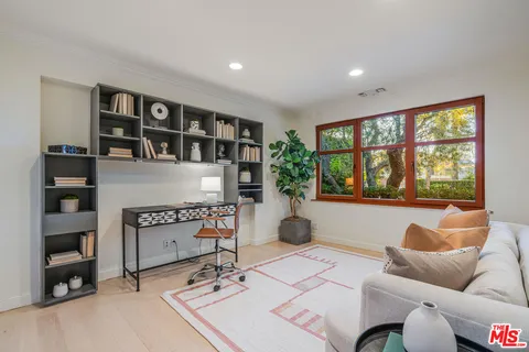 a living room with furniture and a floor to ceiling window