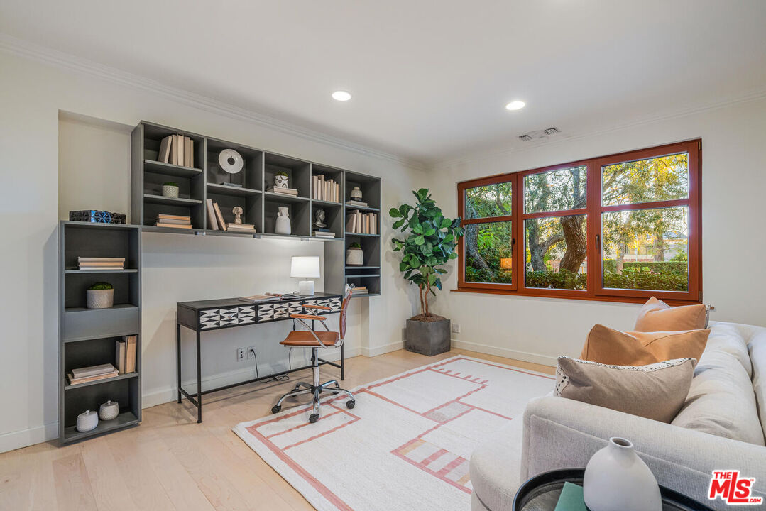 2232 Stradella Road Los Angeles, CA 90077 - Photo 18 of 48 a living room with furniture and a floor to ceiling window