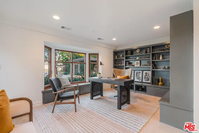 a reading room with furniture and a book shelf