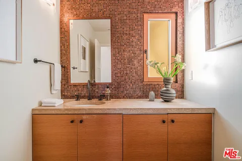 a bathroom with a double vanity sink and a mirror