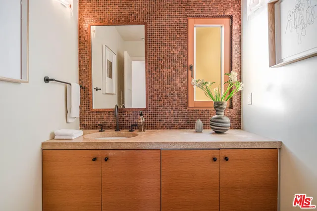a bathroom with a double vanity sink and a mirror