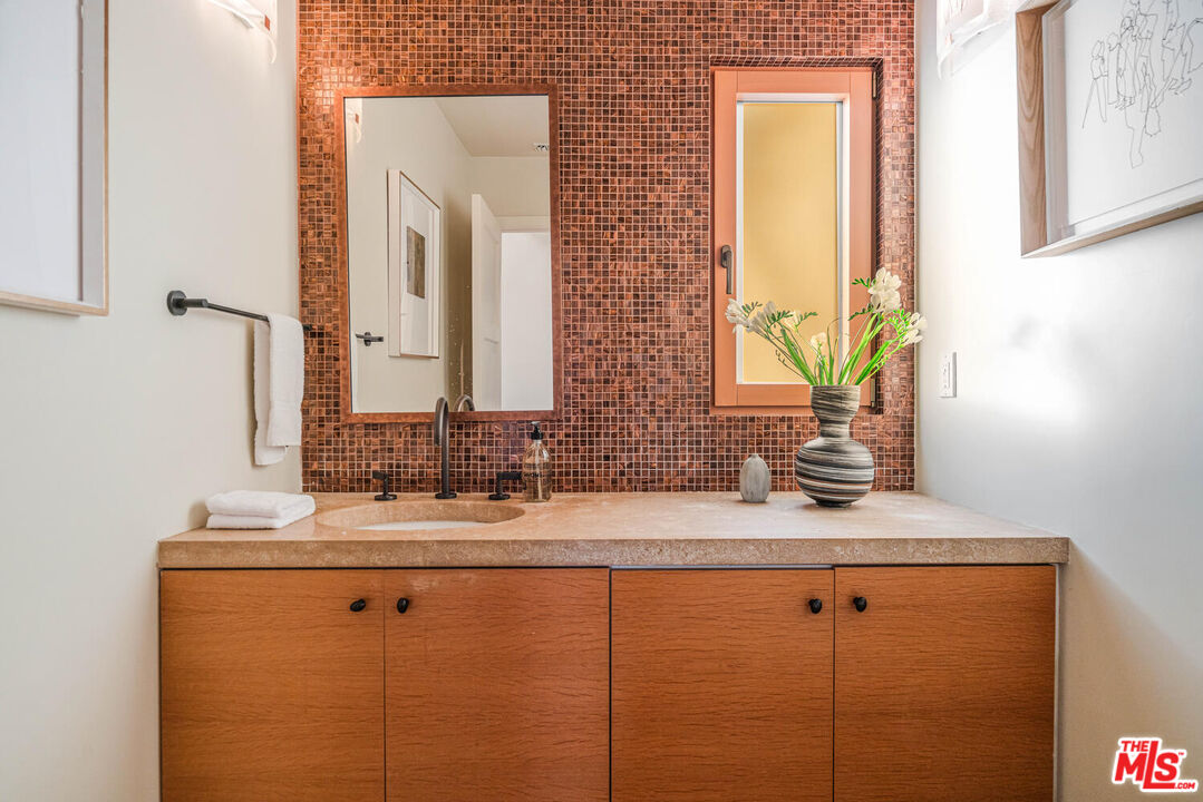 2232 Stradella Road Los Angeles, CA 90077 - Photo 20 of 48 a bathroom with a double vanity sink and a mirror
