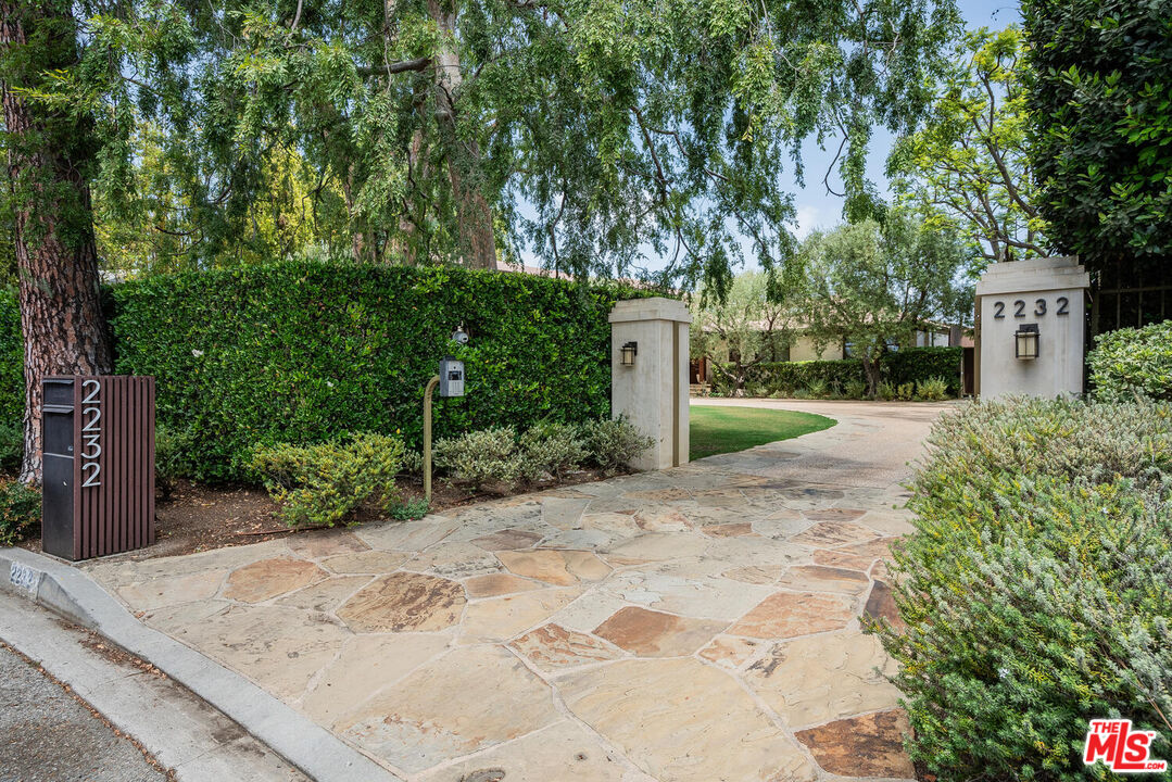 2232 Stradella Road Los Angeles, CA 90077 - Photo 2 of 48 a front view of a house with a yard and tree