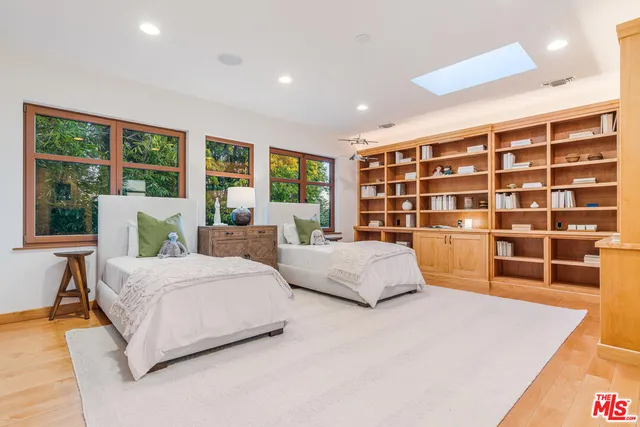 a spacious bedroom with a large bed and a large window