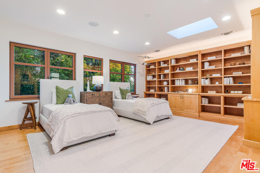 2232 Stradella Road Los Angeles, CA 90077 - Photo 23 of 48 a spacious bedroom with a large bed and a large window