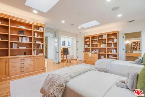 a spacious bedroom with a large bed and a window