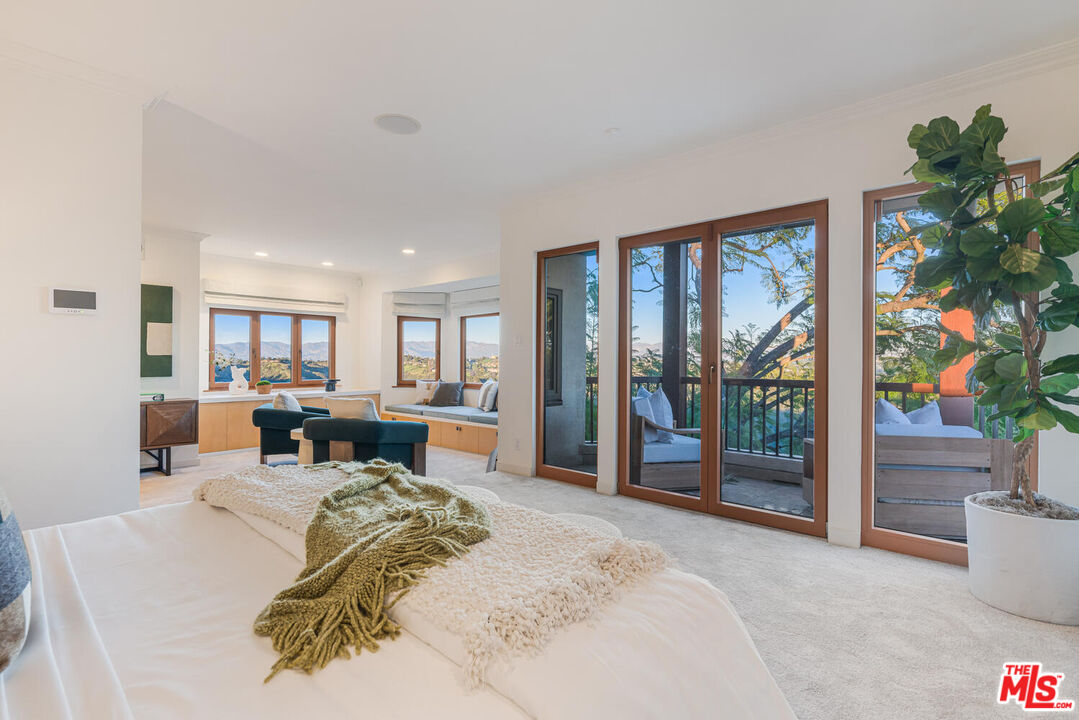 2232 Stradella Road Los Angeles, CA 90077 - Photo 28 of 48 a bed room with a bed and a large window