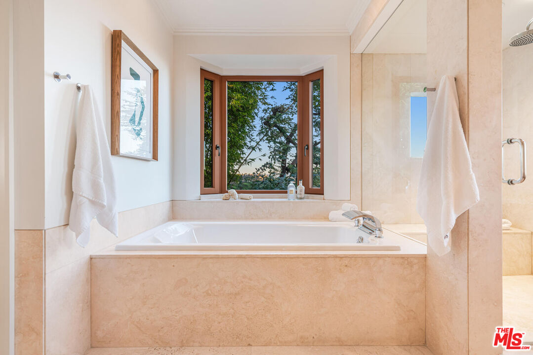 2232 Stradella Road Los Angeles, CA 90077 - Photo 29 of 48 a bath tub sitting in a bathroom next to a window