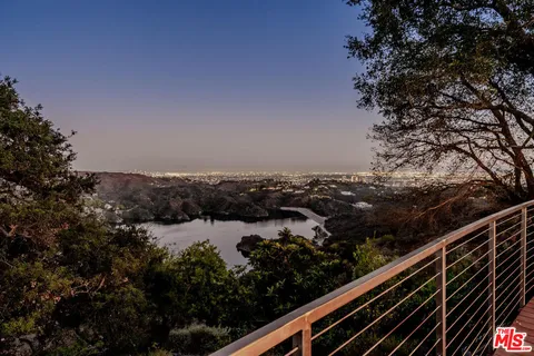 a view of a balcony with wooden floor and outdoor space