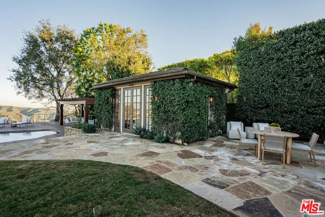 a view of a chair and table in backyard