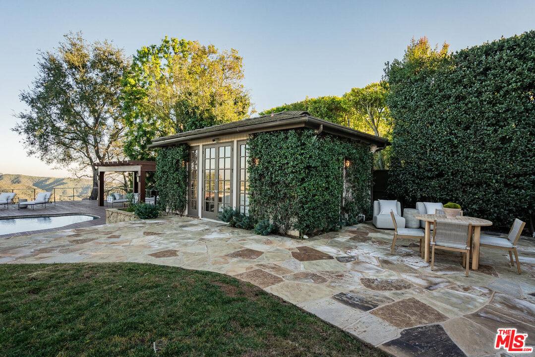 2232 Stradella Road Los Angeles, CA 90077 - Photo 44 of 48 a view of a chair and table in backyard