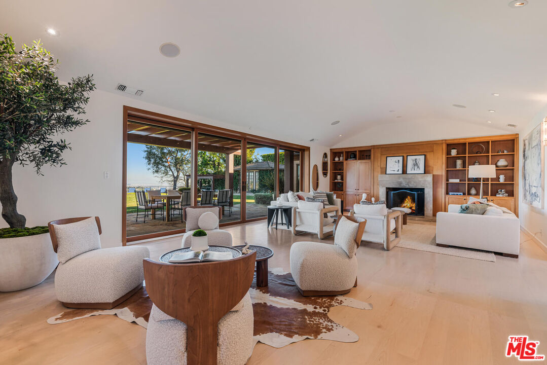 2232 Stradella Road Los Angeles, CA 90077 - Photo 6 of 48 a living room with fireplace furniture and a large window